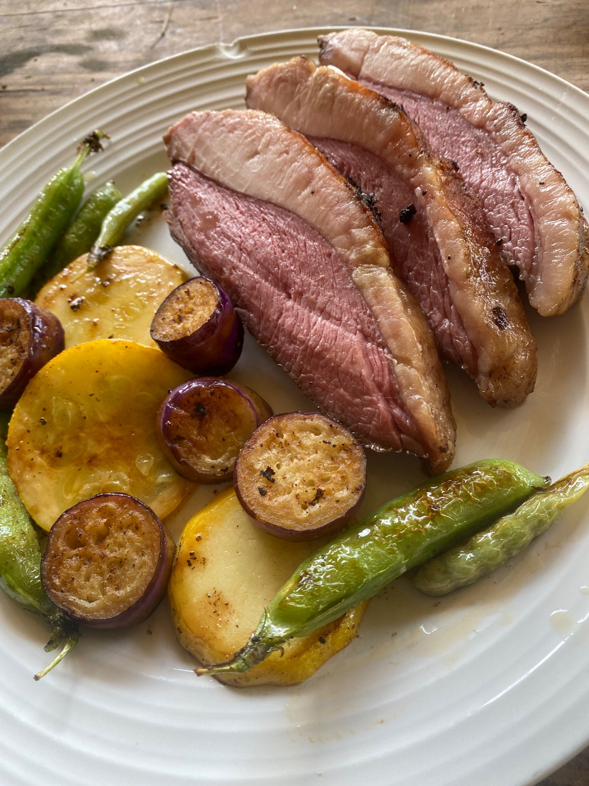 Sliced Carrell Farms water buffalo picanha served with garden vegetables