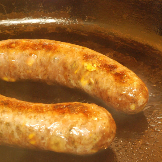 Carrell Farms water buffalo Boudin Blanc sausage cooking in a skillet