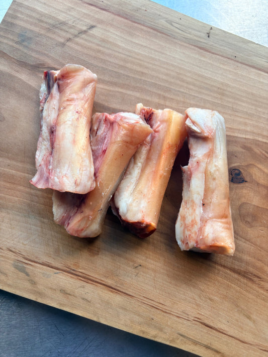 Raw Carrell Farms water buffalo tendon on a wooden cutting board