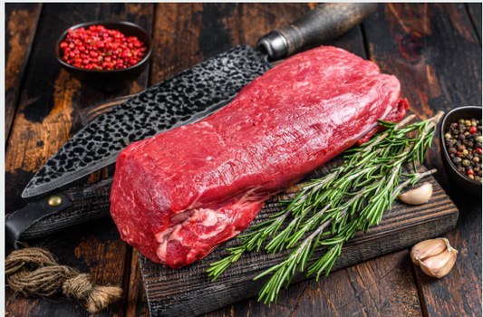Whole raw Carrell Farms water buffalo tenderloin with rosemary, garlic, and peppercorns